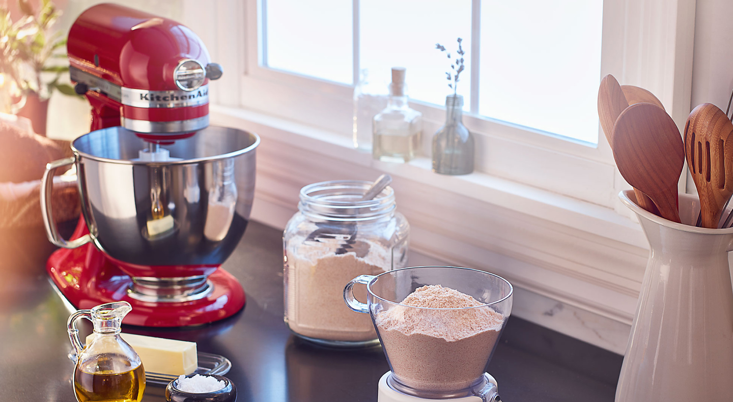 Red KitchenAid® stand mixer on countertop with baking ingredients