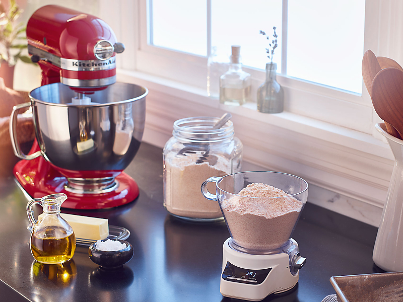 Red KitchenAid® stand mixer on countertop with baking ingredients