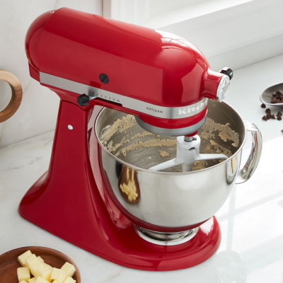 Red KitchenAid® stand mixer with stainless steel bowl and flat beater attachment