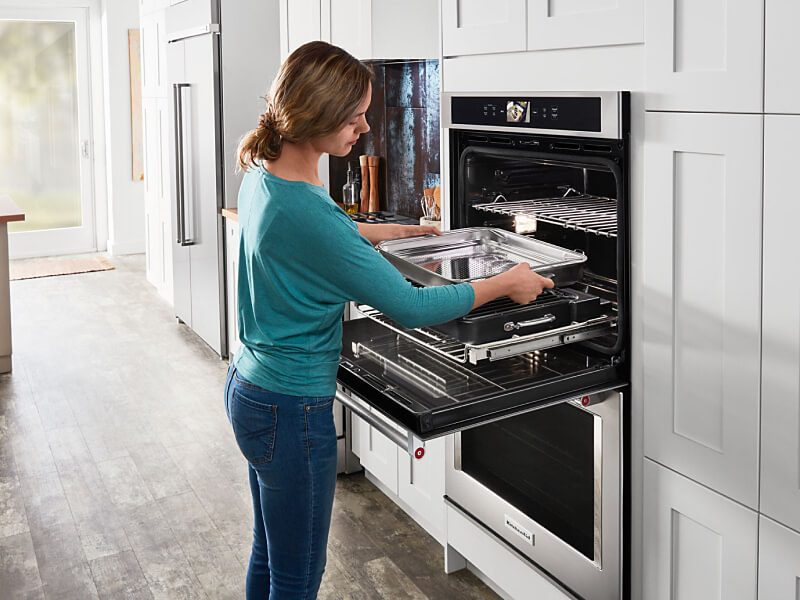 Person prepping their KitchenAid® oven to make ribs.