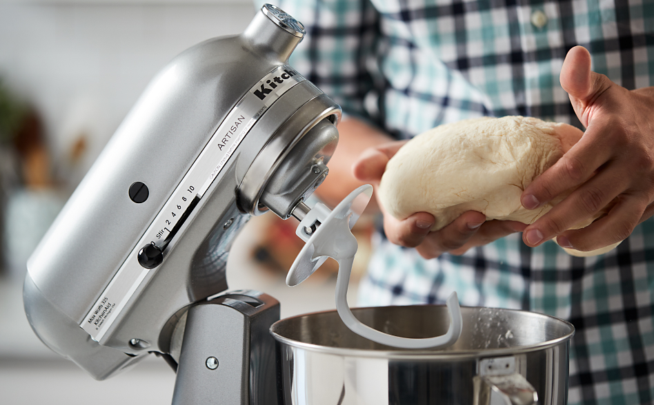 Person shaping sandwich bread dough from stand mixer