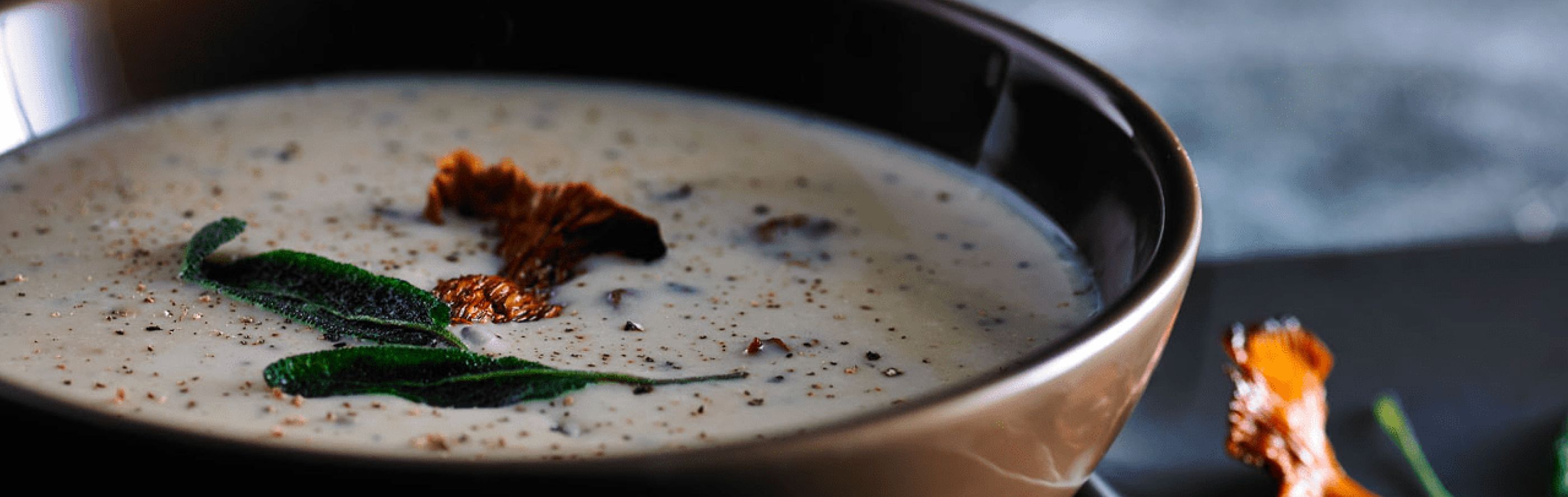 Close-up of blended soup with seasonings in a bowl