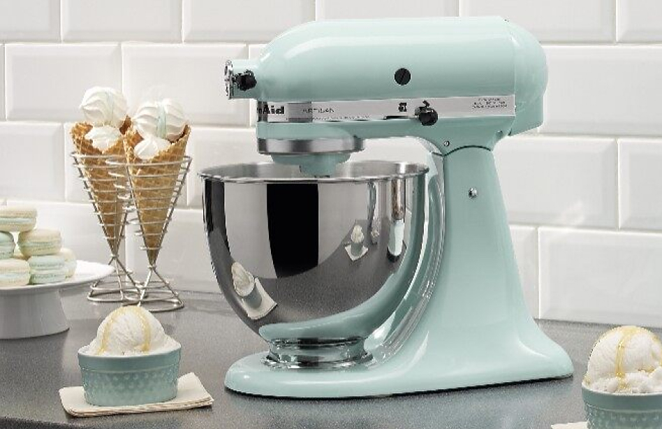 Bowls of ice cream and ice cream cones next to a light blue stand mixer