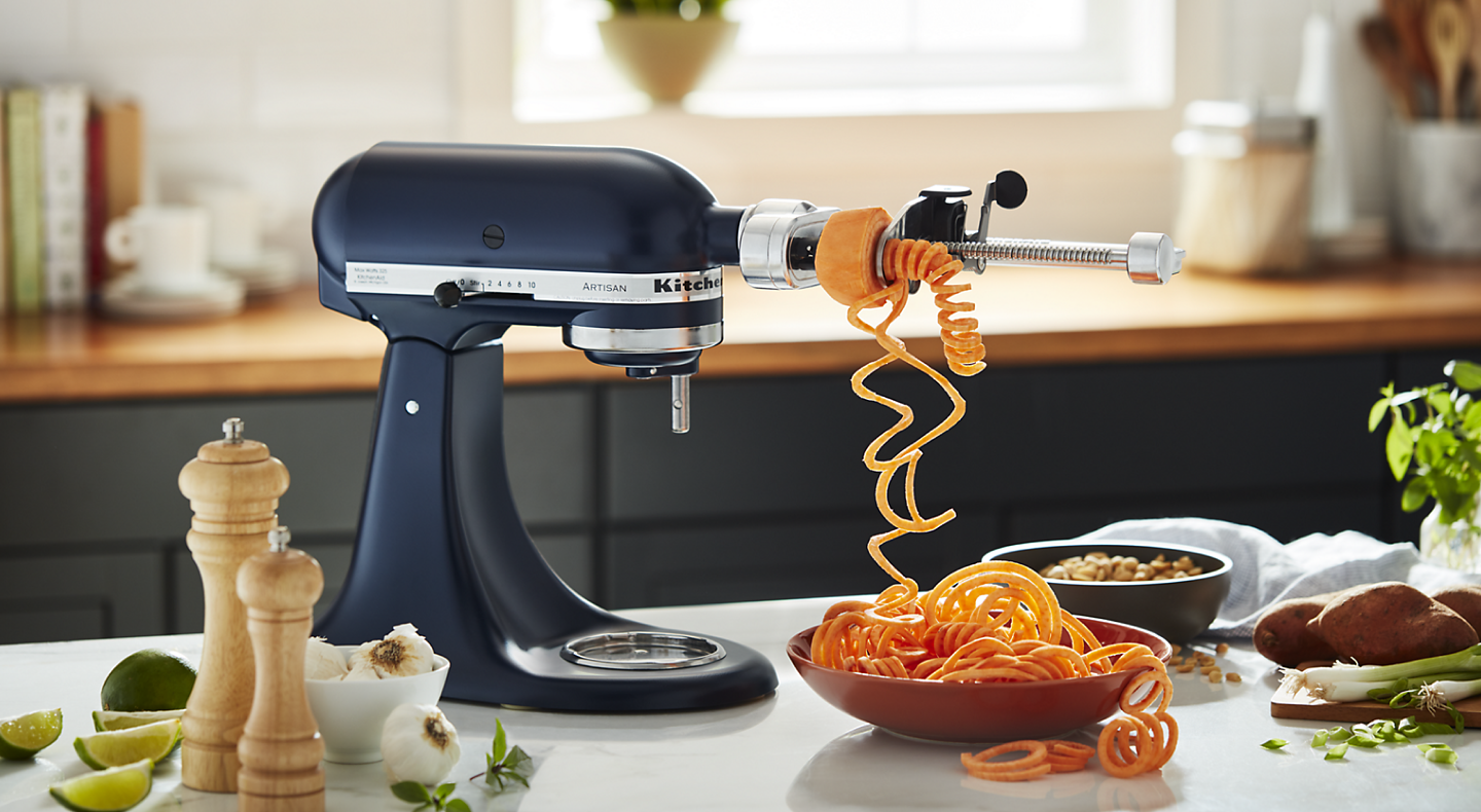 KitchenAid® Spiralizer Attachment spiralizing veggie noodles into bowl