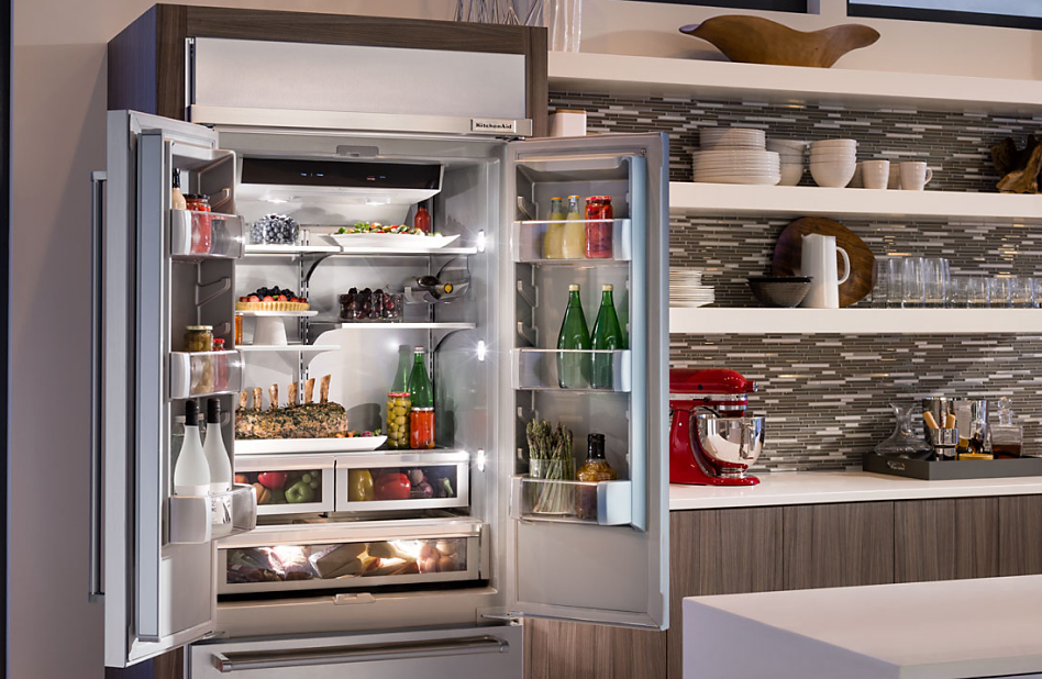 Opened French Door refrigerator with red KitchenAid® Stand Mixer on the adjacent counter