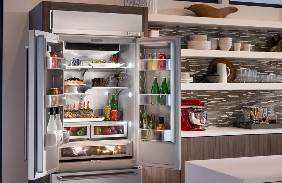 Opened French Door refrigerator with red KitchenAid® Stand Mixer on the adjacent counter Opened French Door refrigerator with red KitchenAid® Stand Mixer on the adjacent counter