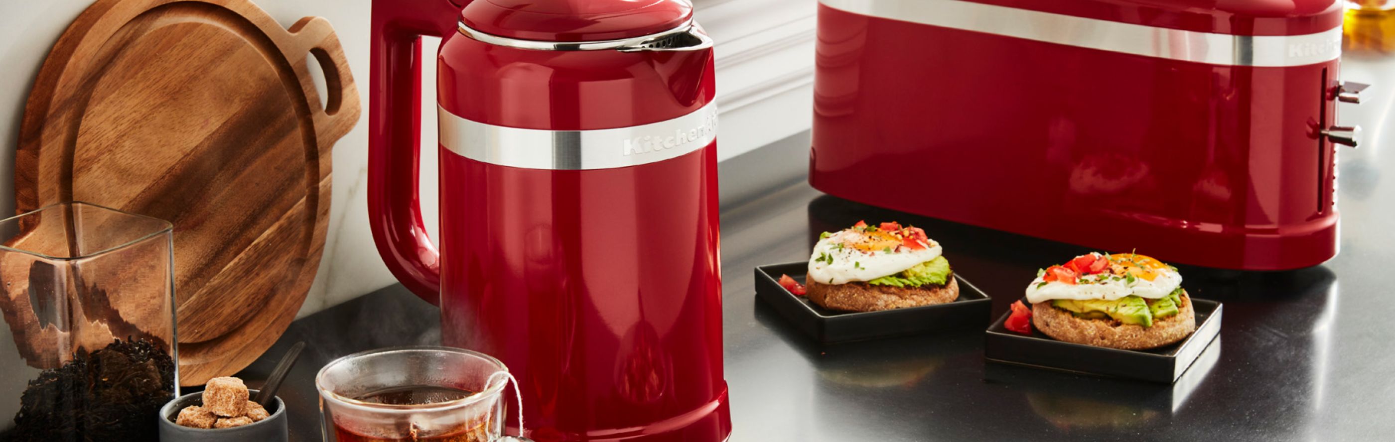 Red KitchenAid® kettle next to a breakfast spread