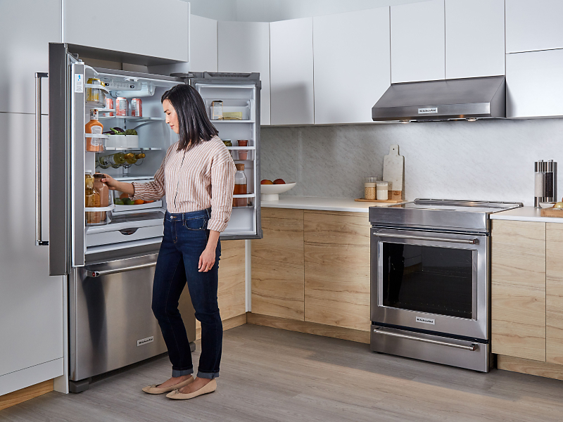 Person removing item from KitchenAid® refrigerator