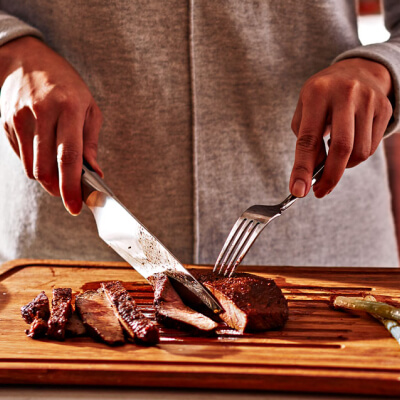 Person slicing steak