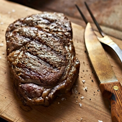 Cooked steak resting on a cutting board