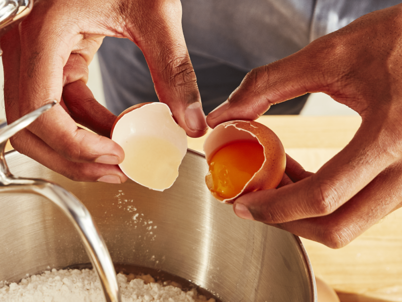 Hands cracking an egg