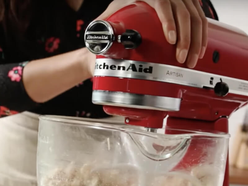 KitchenAid® stand mixer shredding cooked chicken.
