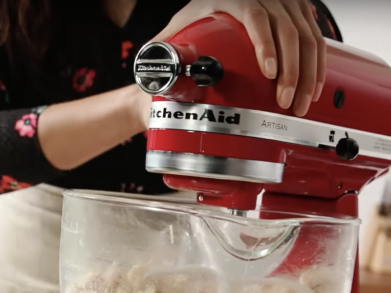 KitchenAid® stand mixer shredding cooked chicken.