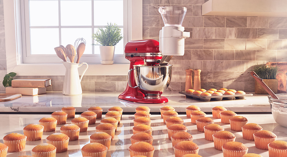 Rows of cupcakes in front of a KitchenAid® stand mixer 