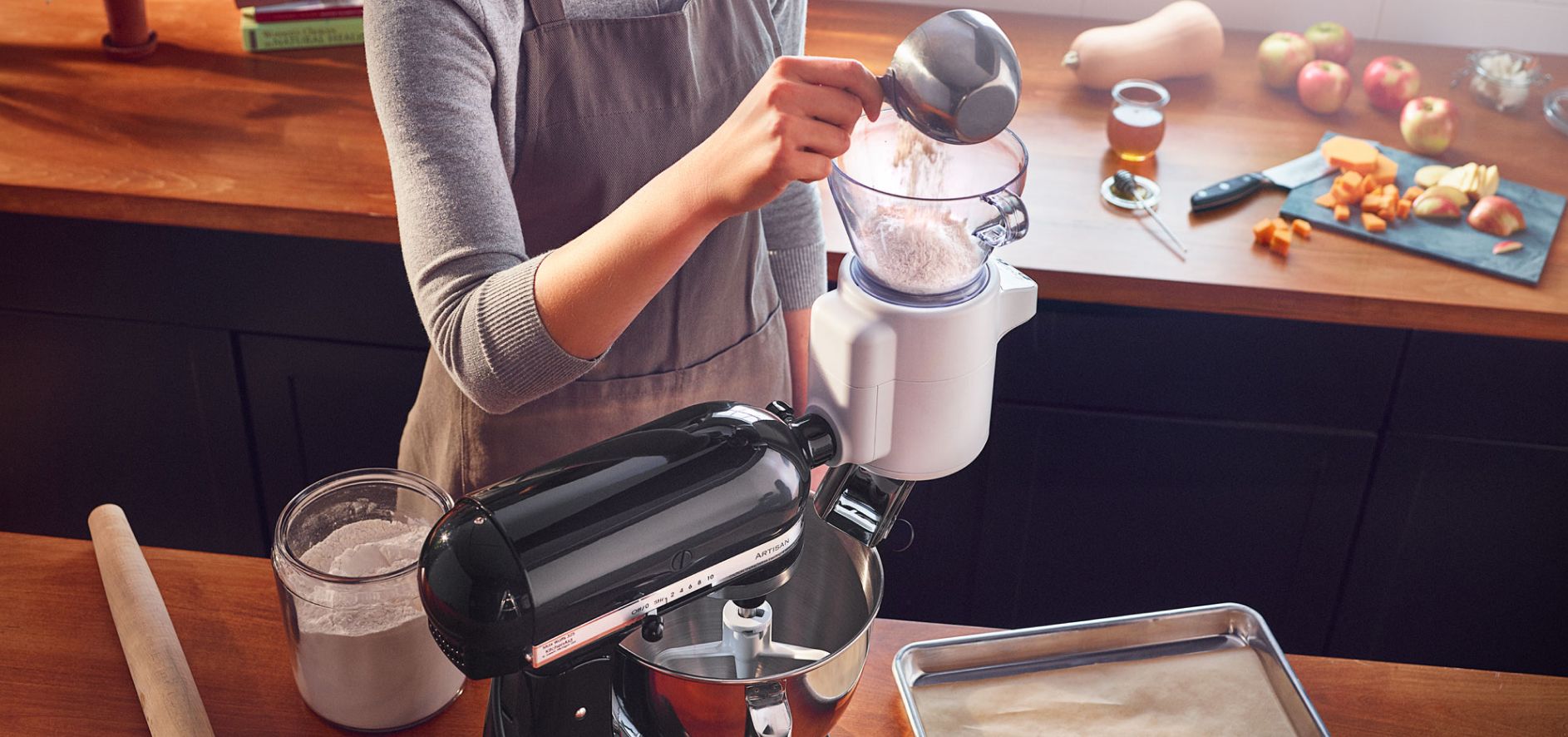 Person sifting flour in a stand mixer sifting attachment