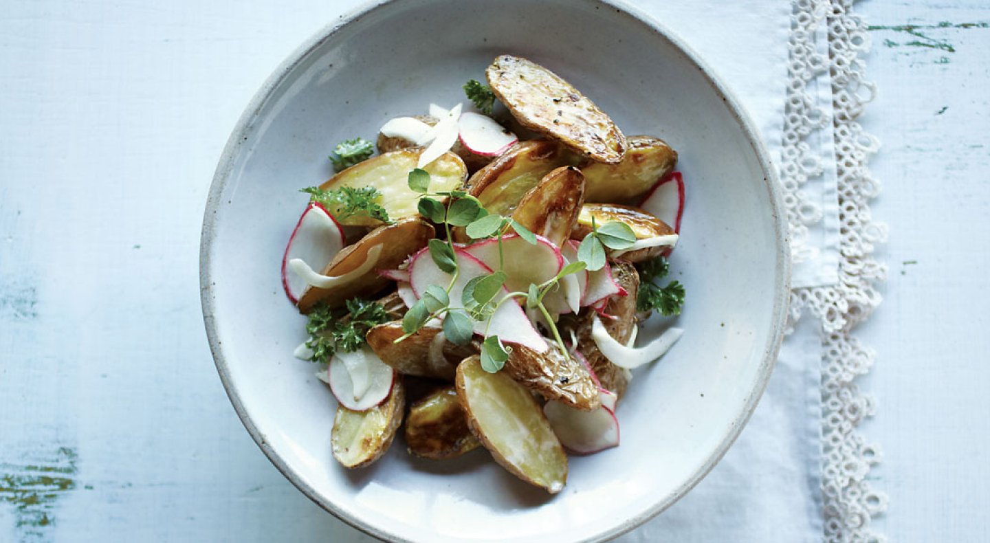 Plated roast potatoes with radishes and herbs