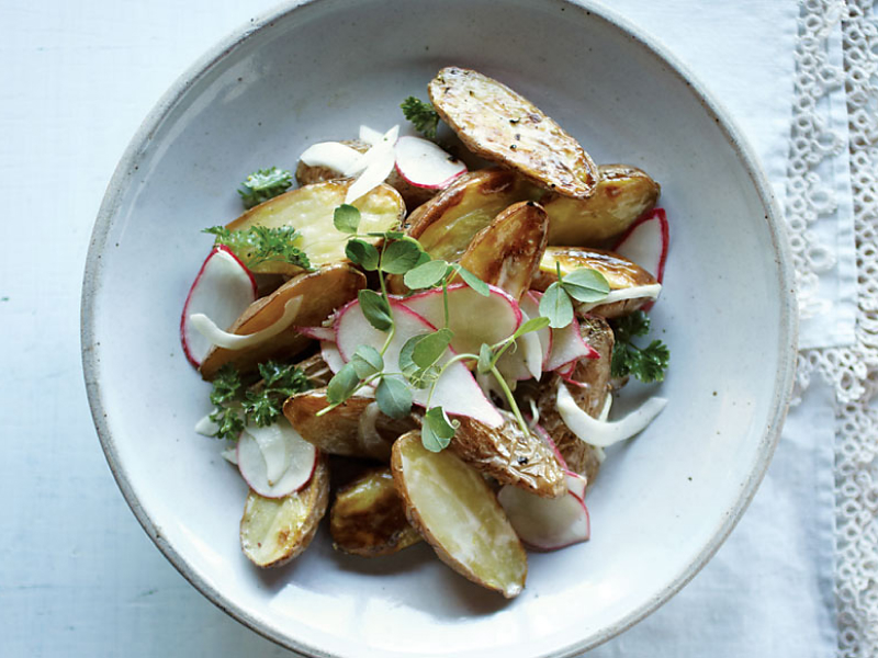Plated roast potatoes with radishes and herbs