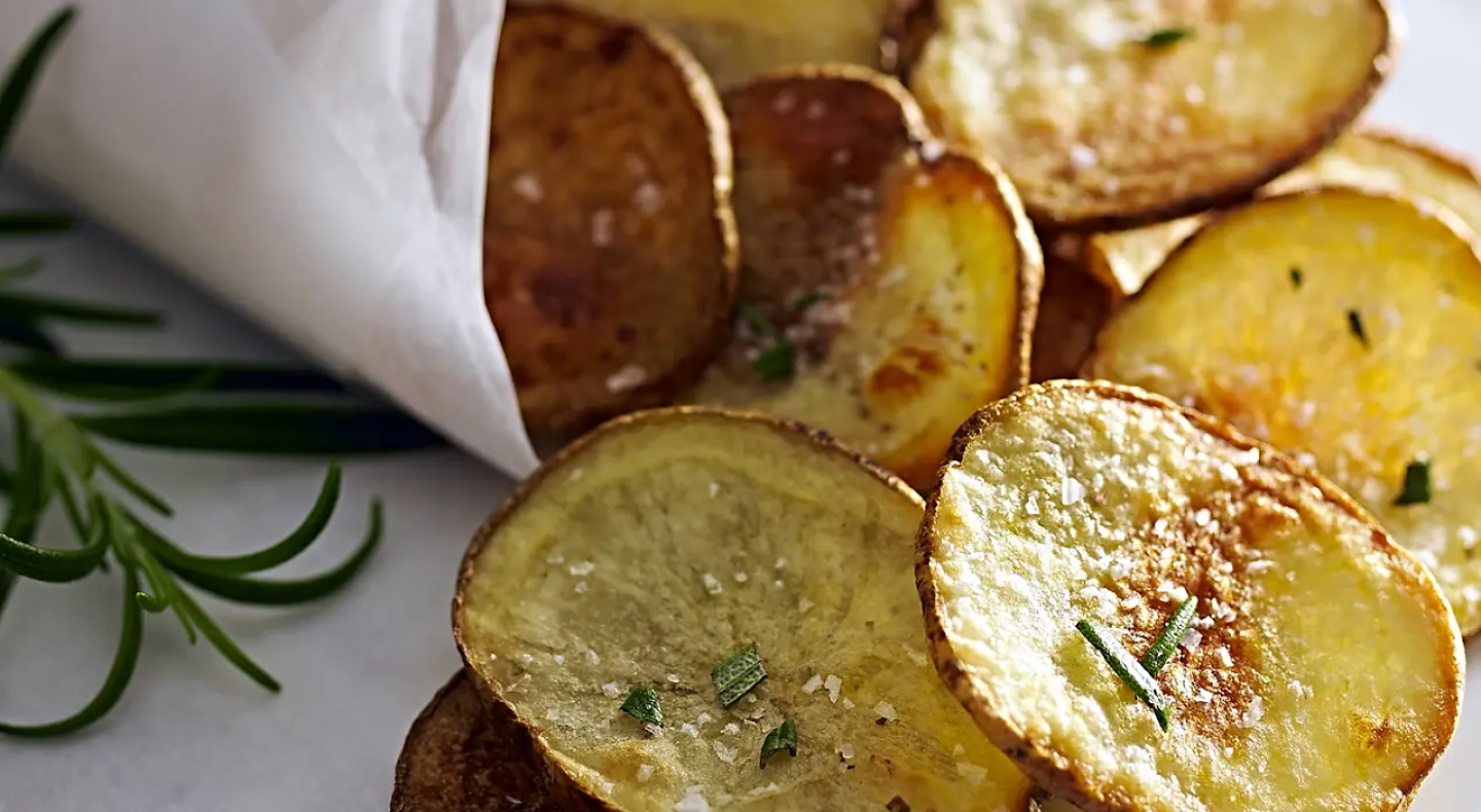 Homemade potato chips garnished with chives