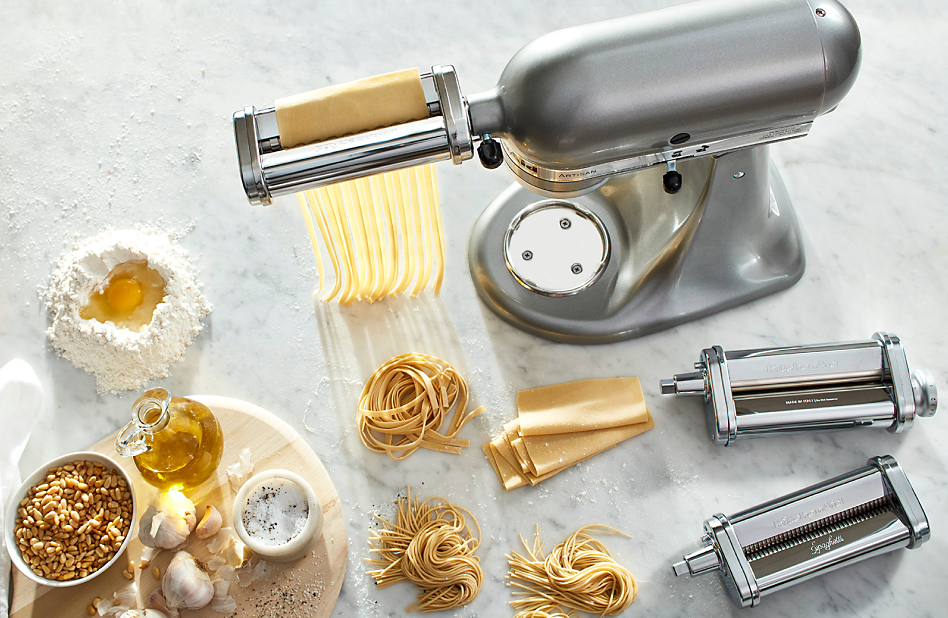 A silver KitchenAid® stand mixer with pasta making attachments