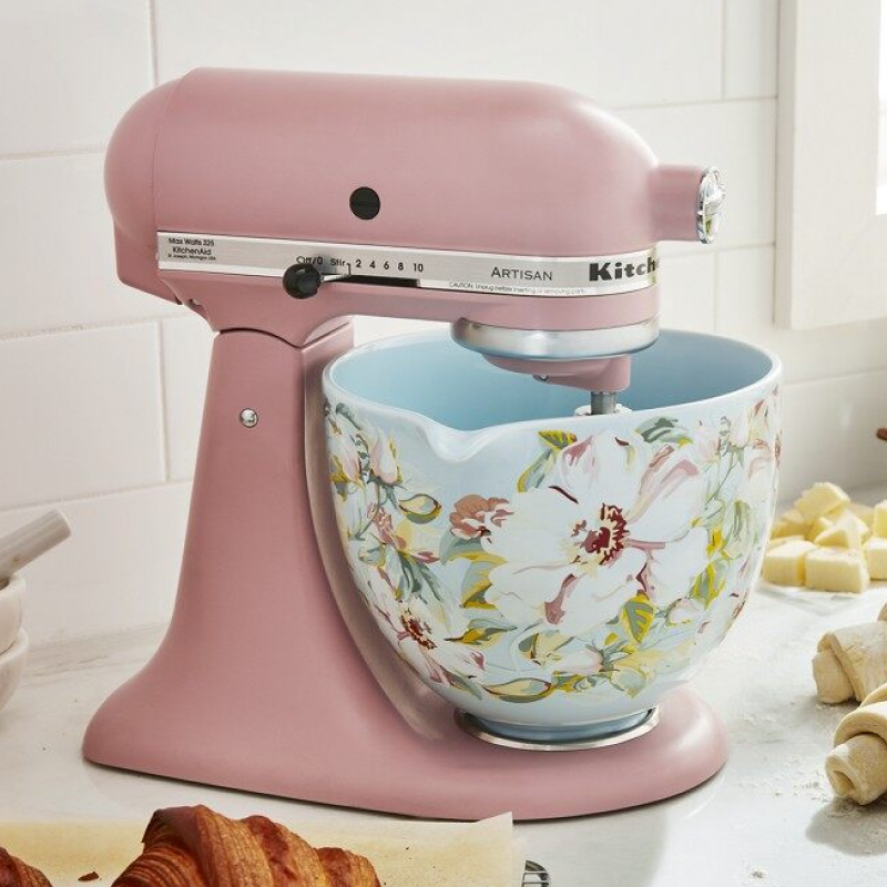 A rose gold KitchenAid® stand mixer with a flowery bowl.