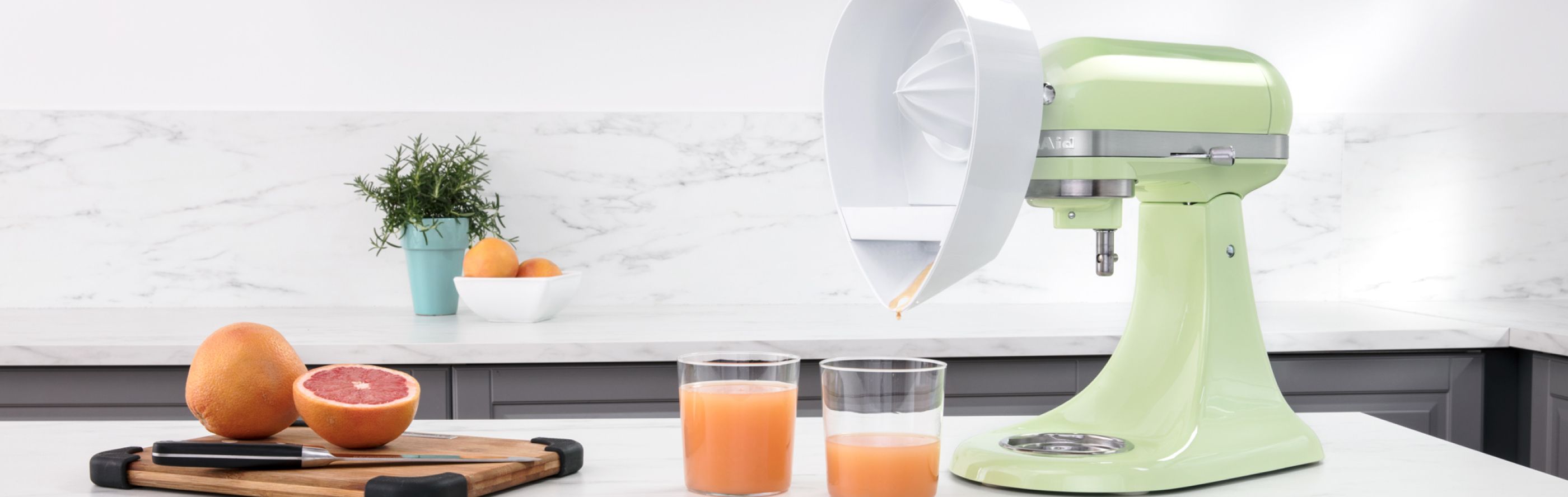 Fresh juice made with a green KitchenAid® stand mixer and Citrus Juicer Attachment