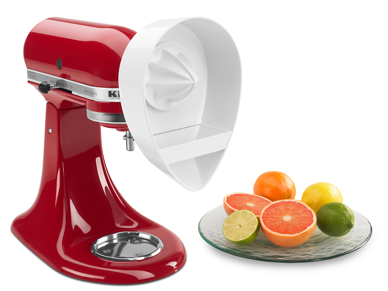 Sliced fruits next to a red KitchenAid® stand mixer with Citrus Juicer Attachment