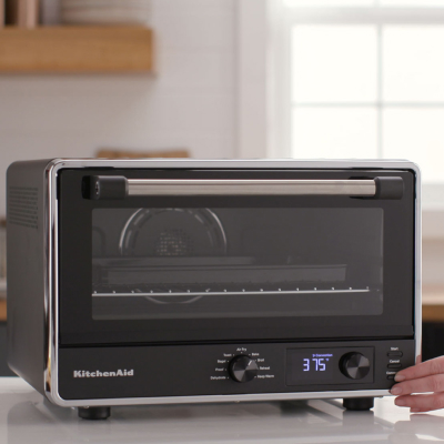 A black KitchenAid® countertop oven with a closed door
