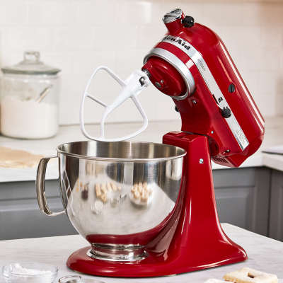 A red KitchenAid® stand mixer with dough hook attachment.