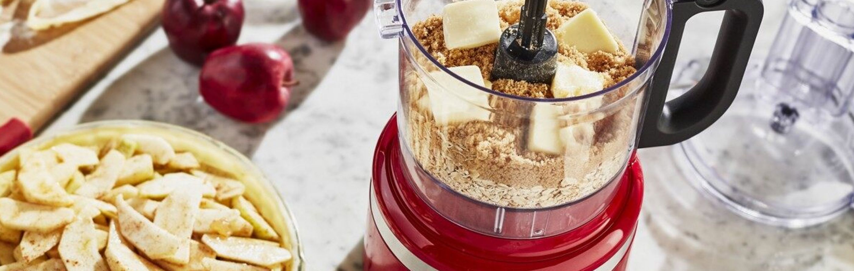 A food processor with butter and graham crackers