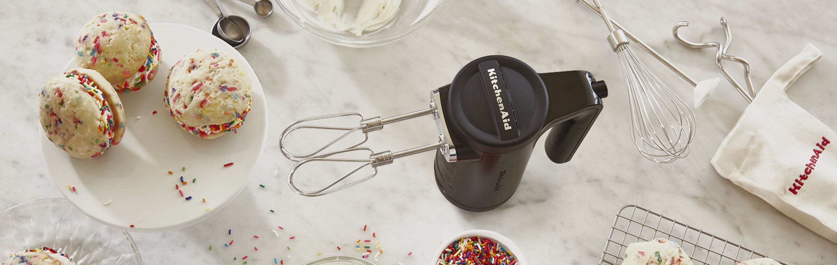 Hand mixer next to cookies on counter
