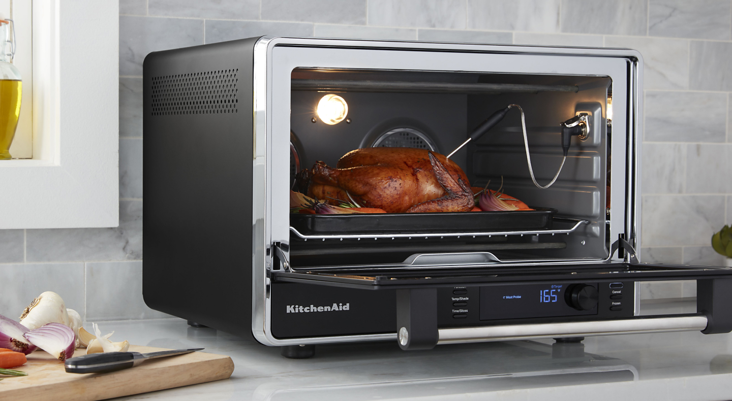 A meat probe measuring the temperature of a roast chicken
