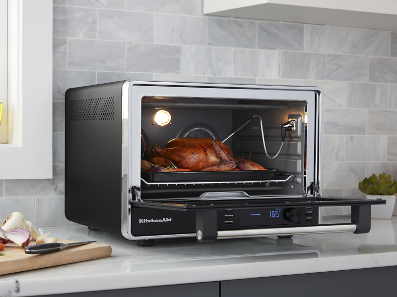 A meat probe measuring the temperature of a roast chicken