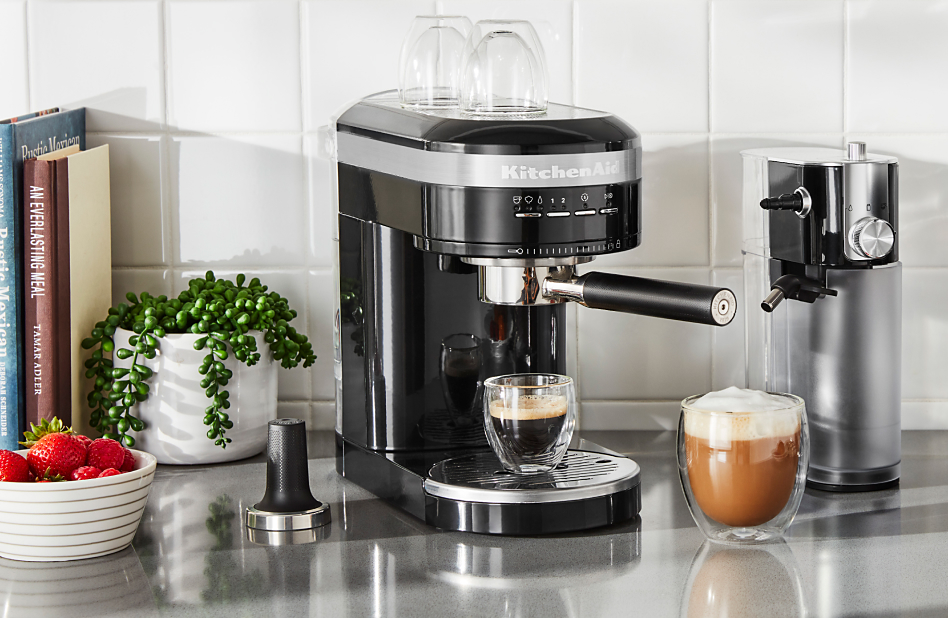 Black espresso machine with milk frother attachment and drinks