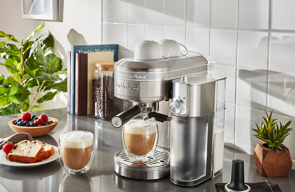 Stainless steel espresso machine on counter with cappuccinos