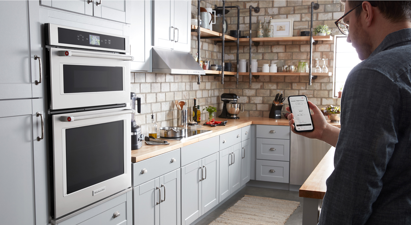 Maker checking settings on phone for KitchenAid Smart Oven+