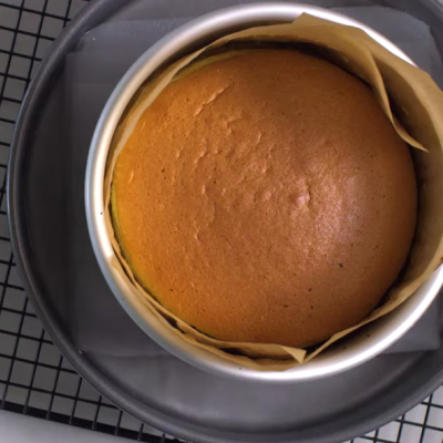 Cake in pan with parchment paper.