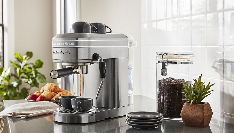 Metal KitchenAid(R) espresso machine on counter making espresso