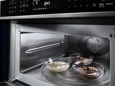 Three small dishes inside open microwave