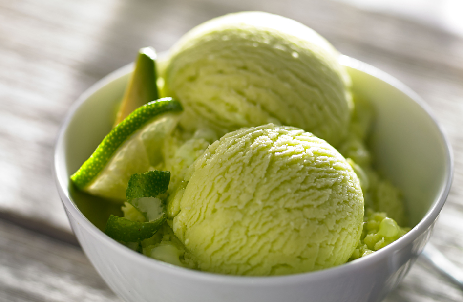  Bowl of homemade green ice cream with lime slices