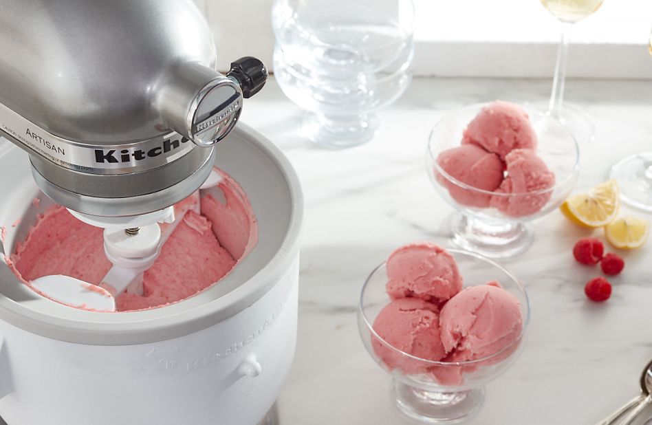 Silver stand mixer with Ice Cream Maker attachment churning raspberry lemon ice cream
