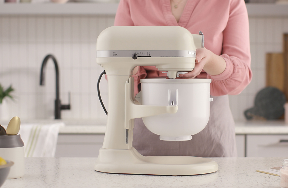 Woman attaching Ice Cream Maker attachment to stand mixer