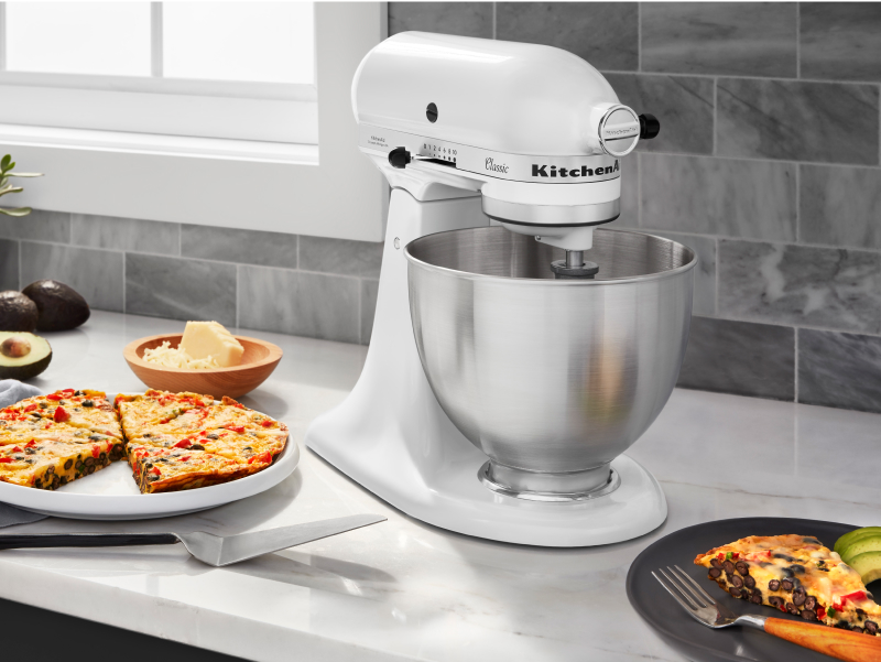 White KitchenAid® stand mixer next to a plate of frittata 