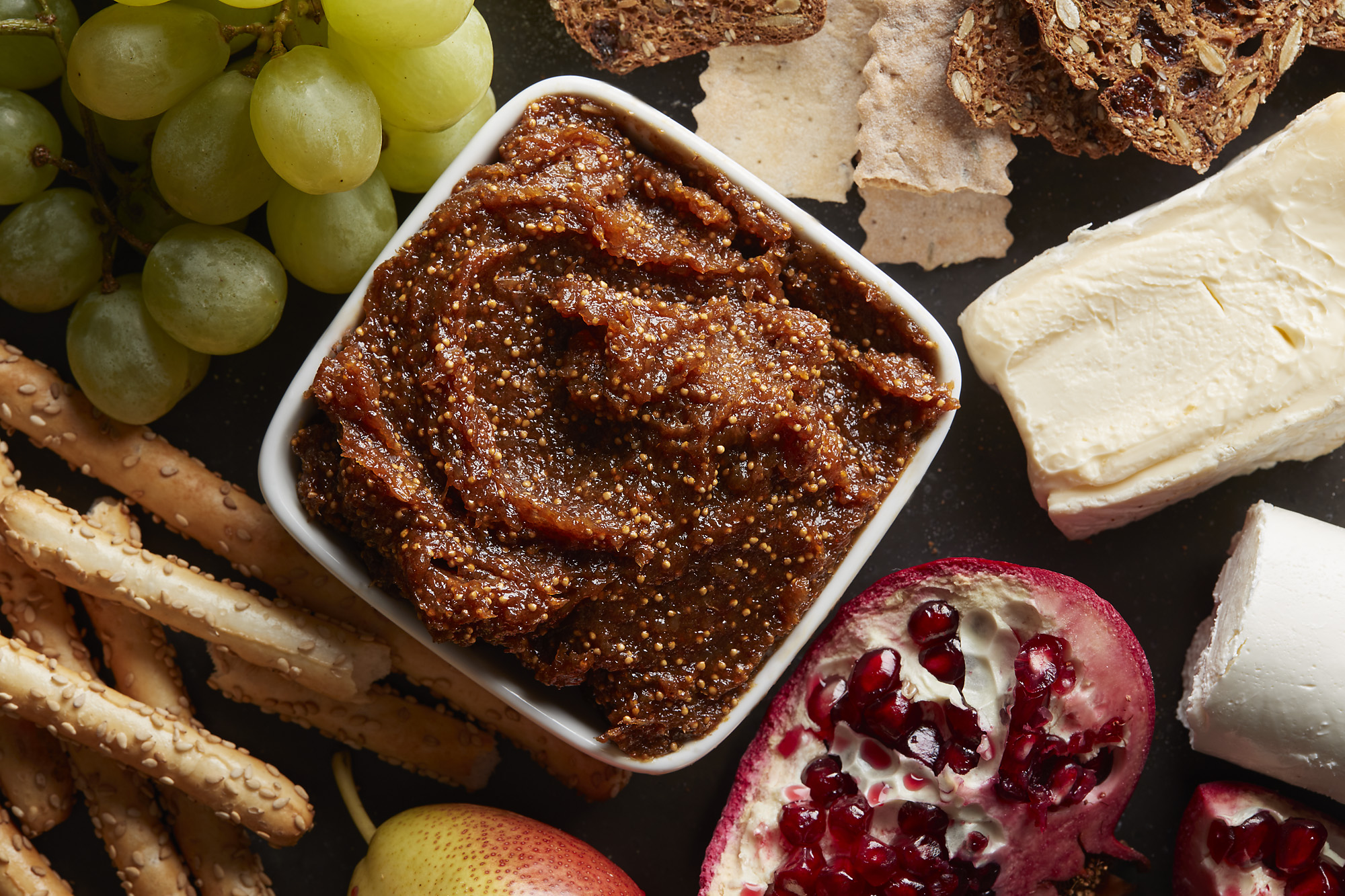 A small bowl of spiced fig jam surrounded by other ingredients