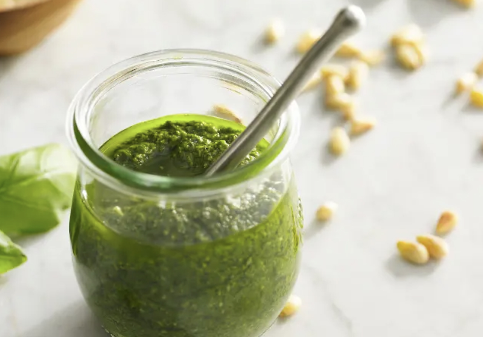 A glass jar filled with pesto