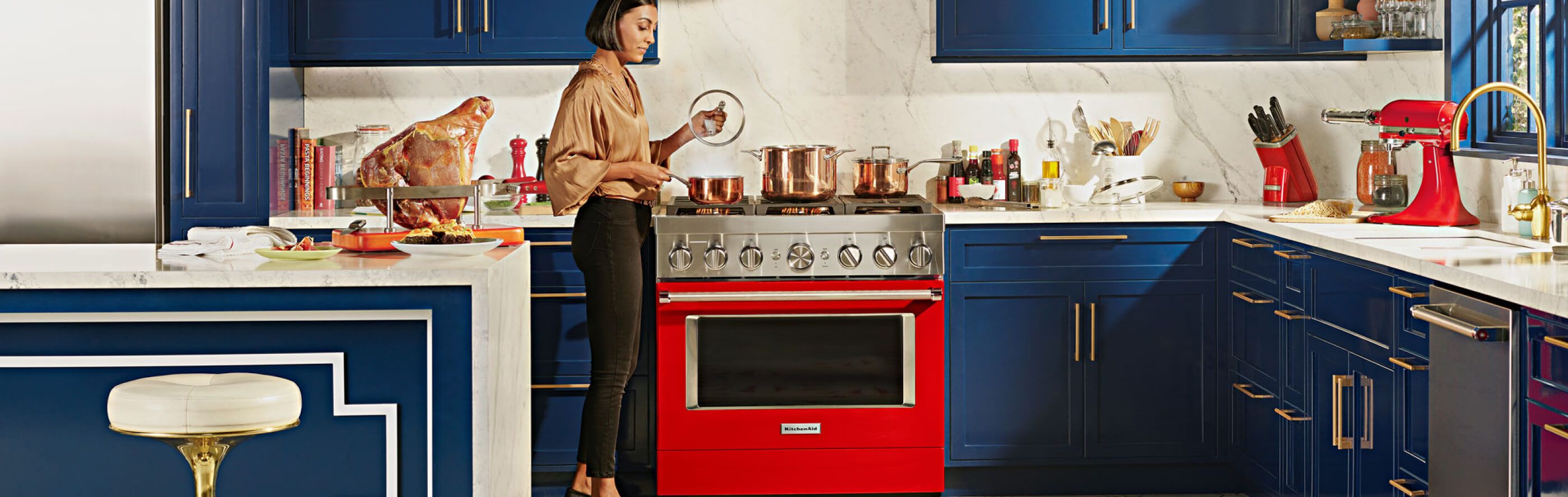 Red KitchenAid® range set in blue, modern kitchen