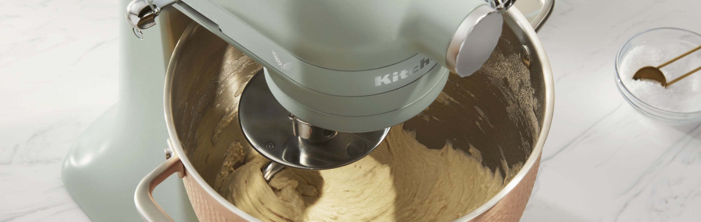 KitchenAid® stand mixer with dough hook mixing dough