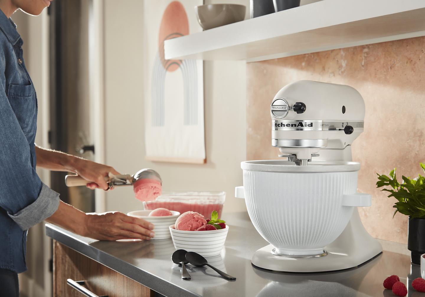  Woman scooping ice cream into bowls next to stand mixer with KitchenAid®  Ice Cream Maker Attachment
