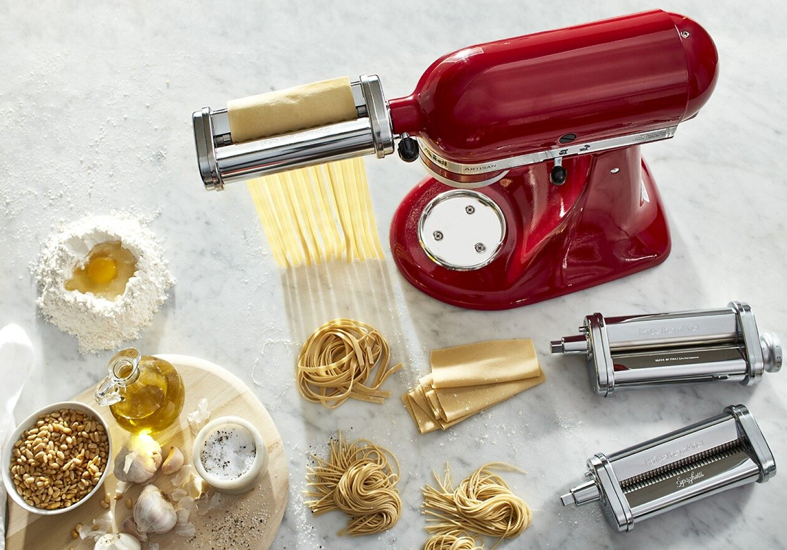 Red KitchenAid® stand mixer with the Pasta Sheet Roller Attachment rolling and cutting pasta