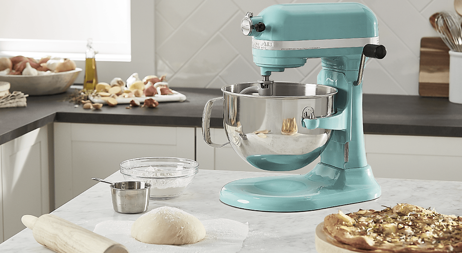 KitchenAid® stand mixer with dough and rolling pin on countertop