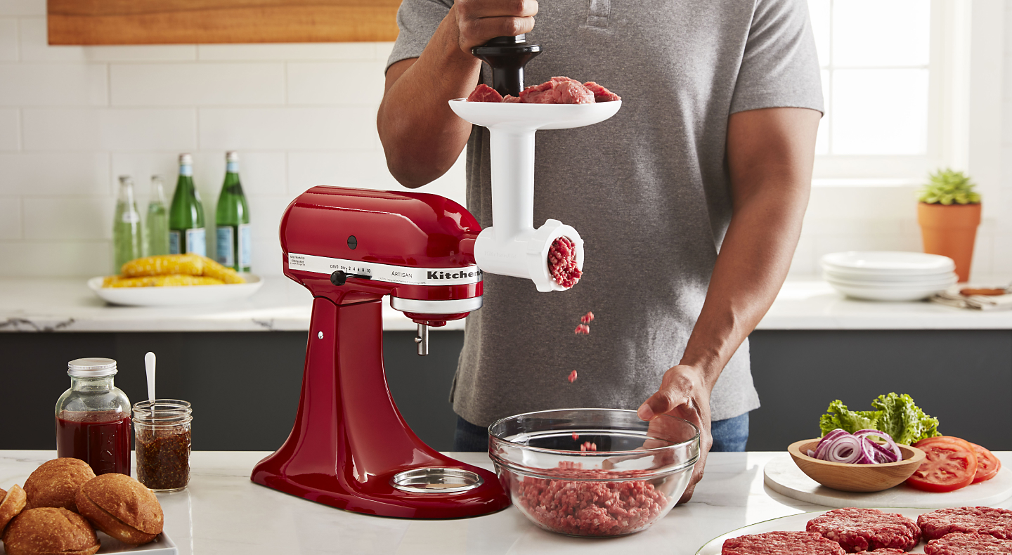 Grinding meat for burgers into a bowl with KitchenAid® Food Grinder